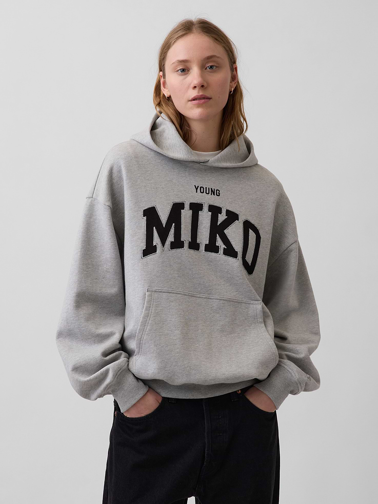 Image 1 of 9, Our iconic Arch Logo Hoodie, reimagined by Young Miko. A limited-edition piece for one of a kind artist. And you., Soft, heavyweight cotton-blend fleece pullover hoodie. In an oversized fit., Hooded neckline., Long sleeves with drop shoulders and banded cuffs., Embroidered Young Miko arch logo at chest., Kanga pocket., Banded hem., This hoodie is made with 14% recycled polyester. Compared to virgin materials, using recycled materials helps to reduce resource use and waste., Explore our GapSweats Guide ., Product #910779
