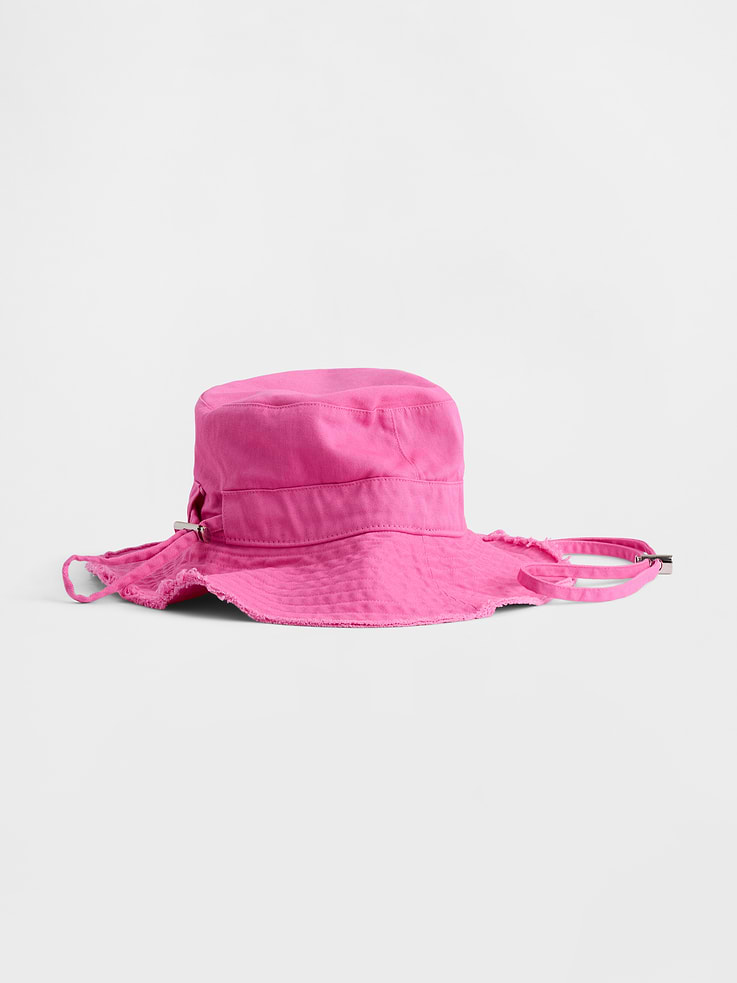 Image 1 of 2, Soft cotton twill bucket hat., Stitching at wide brim., Frayed hem., Adjustable chin strap with buckle closure., This product was made in a factory that invests in gender equity and women’s empowerment through RISE. Learn more at gapinc.com/equity ., Product #876635