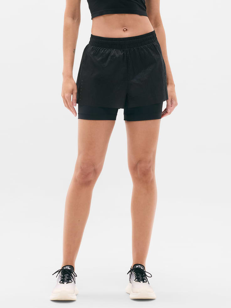 Image 1 of 7, FOR: Hitting your pace in nearly any place, from sidewalks to trailheads, FEEL: Featherlight and water-repellent outer layer with a compressive short, FAVE: Bike shorts offer coverage and convenient side stash pockets, Product #845129