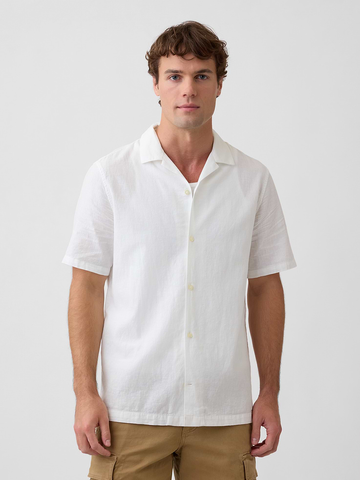Image 1 of 5, Smooth linen blend., Short sleeves., Notch spread collar, button front., Slits at hem., Select styles have allover print or stripes., This product was made in a factory that invests in gender equity and women’s empowerment through RISE. Learn more at, Product #878722
