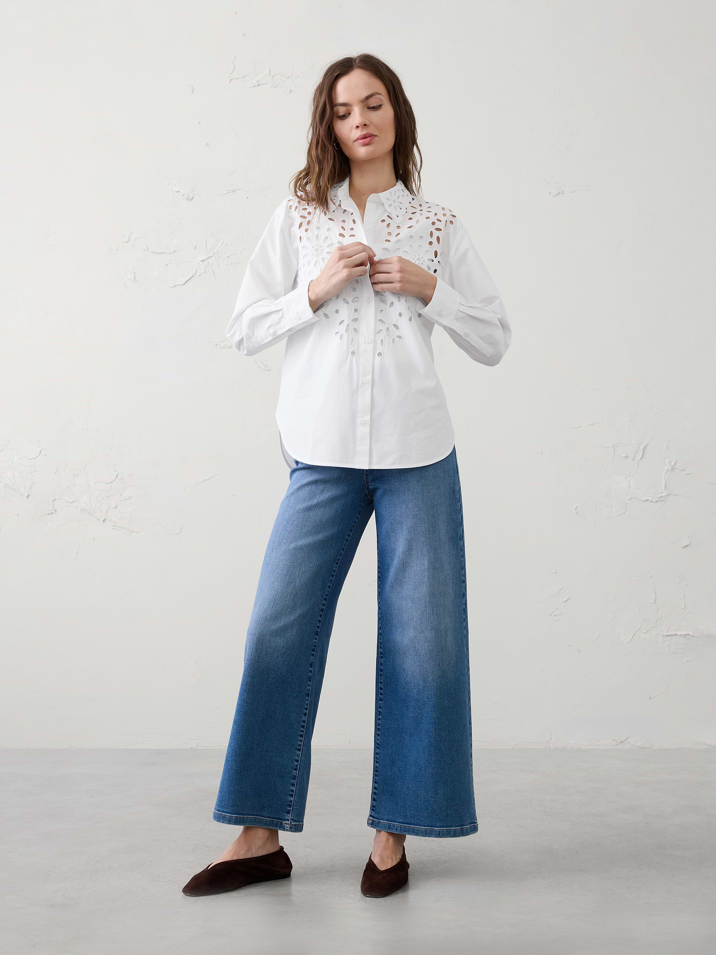 Image 1 of 4, Crafted from crisp cotton with intricate eyelet embroidery across the front., Statement eyelet collar with scalloped edge detailing. Long sleeves with tailored cuffs and button closure., Button front closure., Back yoke with soft pleat., High-low shirttail hem., Made exclusively for Banana Republic Factory., Product #872454