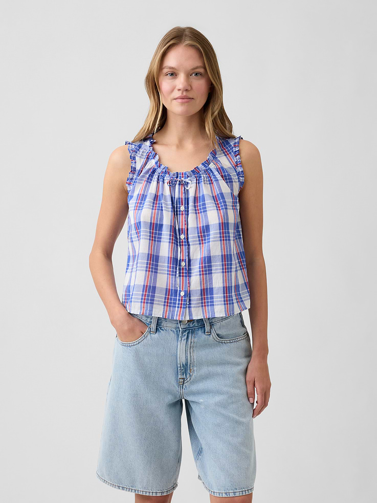 Image 1 of 5, Smooth voile weave., Sleeveless, ruffle trim at shoulders., Ruffle trim and ties at round neckline, button front., Select styles have allover print, stripes, or plaid., This product was made in a factory that invests in gender equity and women’s empowerment through RISE. Learn more at, Product #1174893