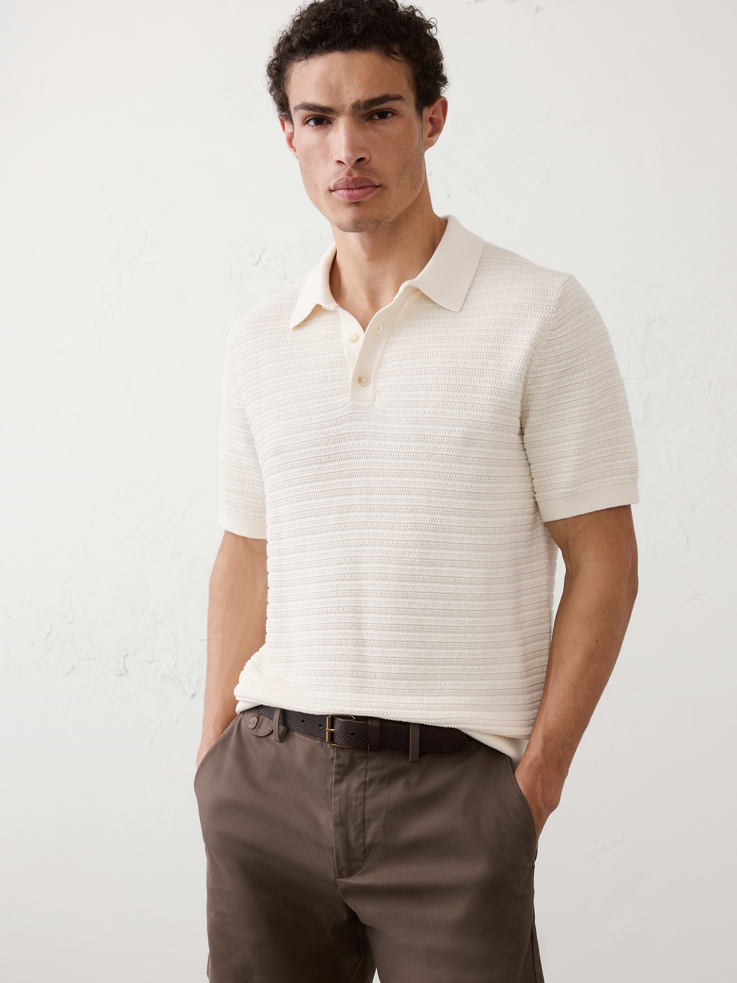 Image 1 of 7, Our classic polo silhouette, reimagined in a textured sweater knit to bring a fresh, trend‑forward feel. An easy, versatile piece for everyday wear., Polo collar with button placket. Short sleeves., Ribbed arm cuffs and hem., Straight hem., Made exclusively for Banana Republic Factory., Product #1173442