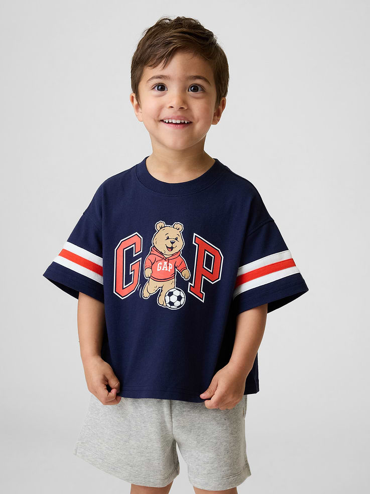 Image 1 of 4, Soft cotton jersey graphic T-shirt in an oversized fit., Crewneck., Short sleeves with Varsity stripes., Gap logo with Brannan Bear tennis graphic at front., Product #898730
