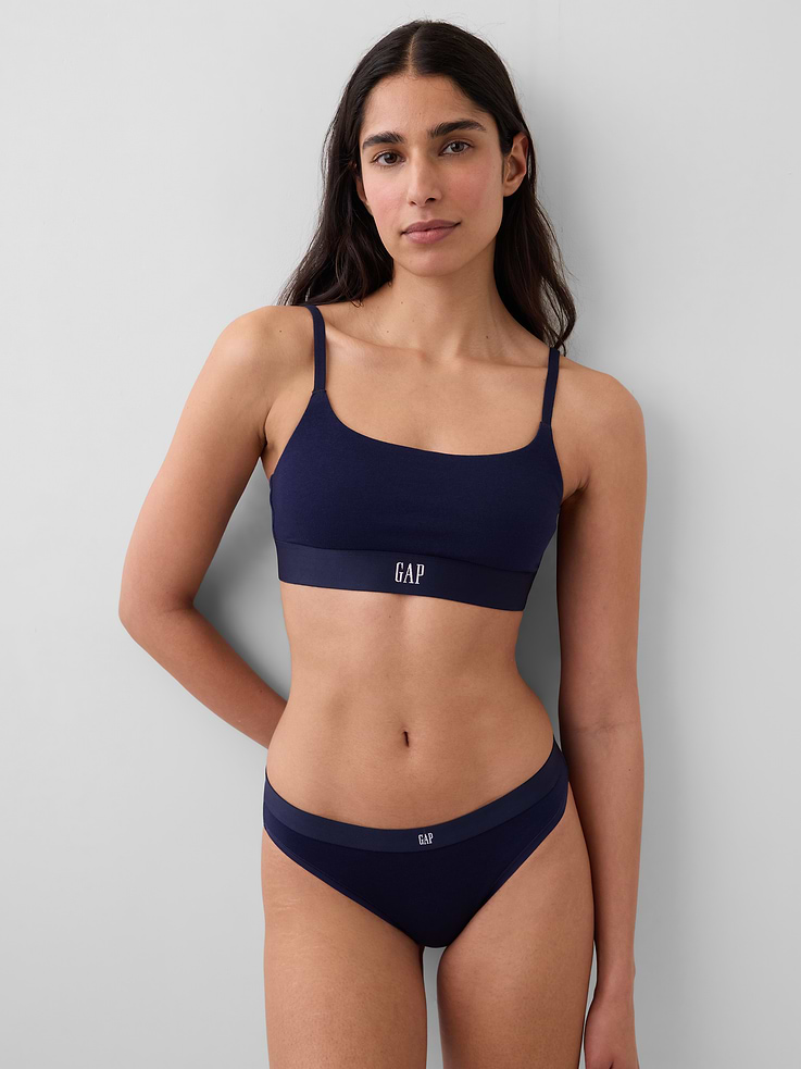 Image 1 of 6, Soft stretch cotton bralette., Scoop neck., Adjustable spaghetti straps., Elasticized hem with Gap logo at front., Made with 92% organically grown cotton, which is grown without the use of synthetic pesticides and fertilizers., This product was made in a factory that invests in gender equity and women’s empowerment through RISE. Learn more at gapinc.com/equity ., Product #886188