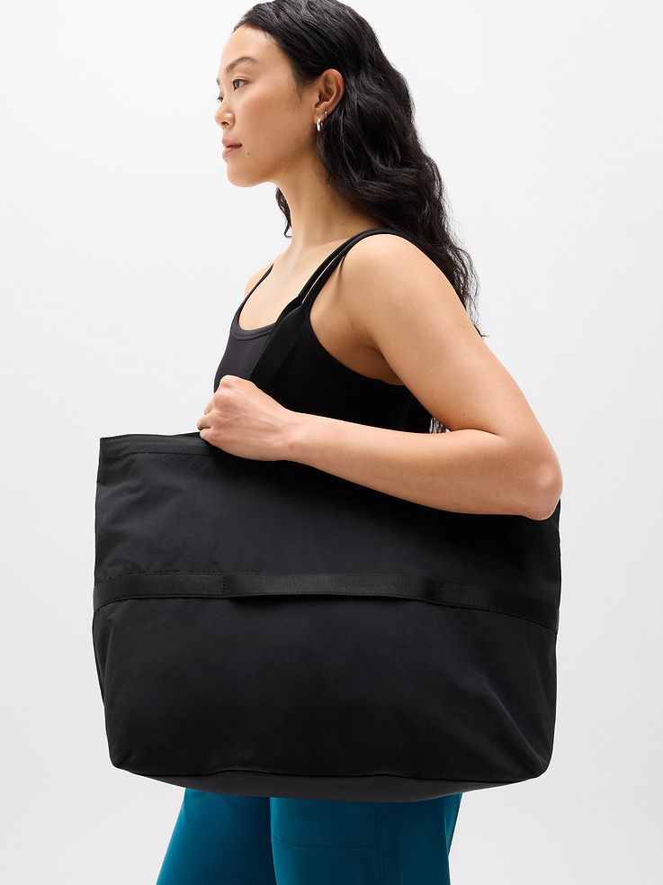 Image 1 of 4, FOR: Stowing stuff for weekly workouts or weekend getaways, FEEL: Ultralight and durable with a crisp, crinkled texture, FAVE: Packs into its own pouch that converts into a wearable crossbody bag, Ribbing provides extra comfort, Product #845114