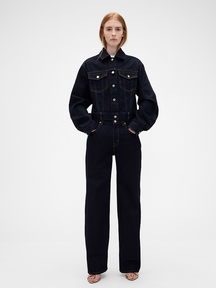 Image 1 of 7, Known for her timeless silhouettes and immaculate tailoring, Victoria Beckham's singular take on style is rooted in a sense of sophisticated ease. Through her lens, our icons take on a new form. Feminine. Powerful. Artistic. Grounded in elevated staples — and denim. The unexpected meeting of Victoria Beckham and Gap., Fit: A full-length jean that's fitted and slightly dipped on the waist & straight all the way down., Fabric: 100% Cotton., Stretch: No Stretch Jeans. Authentic denim that gets better with every wear. Made to wear all day & break in over time., Look: A straight jean in a dark indigo wash., Details: Slight V-dip waistband, zip fly, 5-pocket styling, red stitch detailing, & Gap × Victoria Beckham logo leather patch at back., Responsibly Made: This jean is part of our water-saving Washwell program. Compared with conventional wash methods, Washwell uses at least 20% less water., More Sustainable Cotton: Made with 100% regeneratively grown cotton which is grown using holistic agricultural practices that aim to improve soil health and water retention., This product was made in a factory that invests in gender equity and women’s empowerment through RISE. Learn more at gapinc.com/equity ., Product #902738