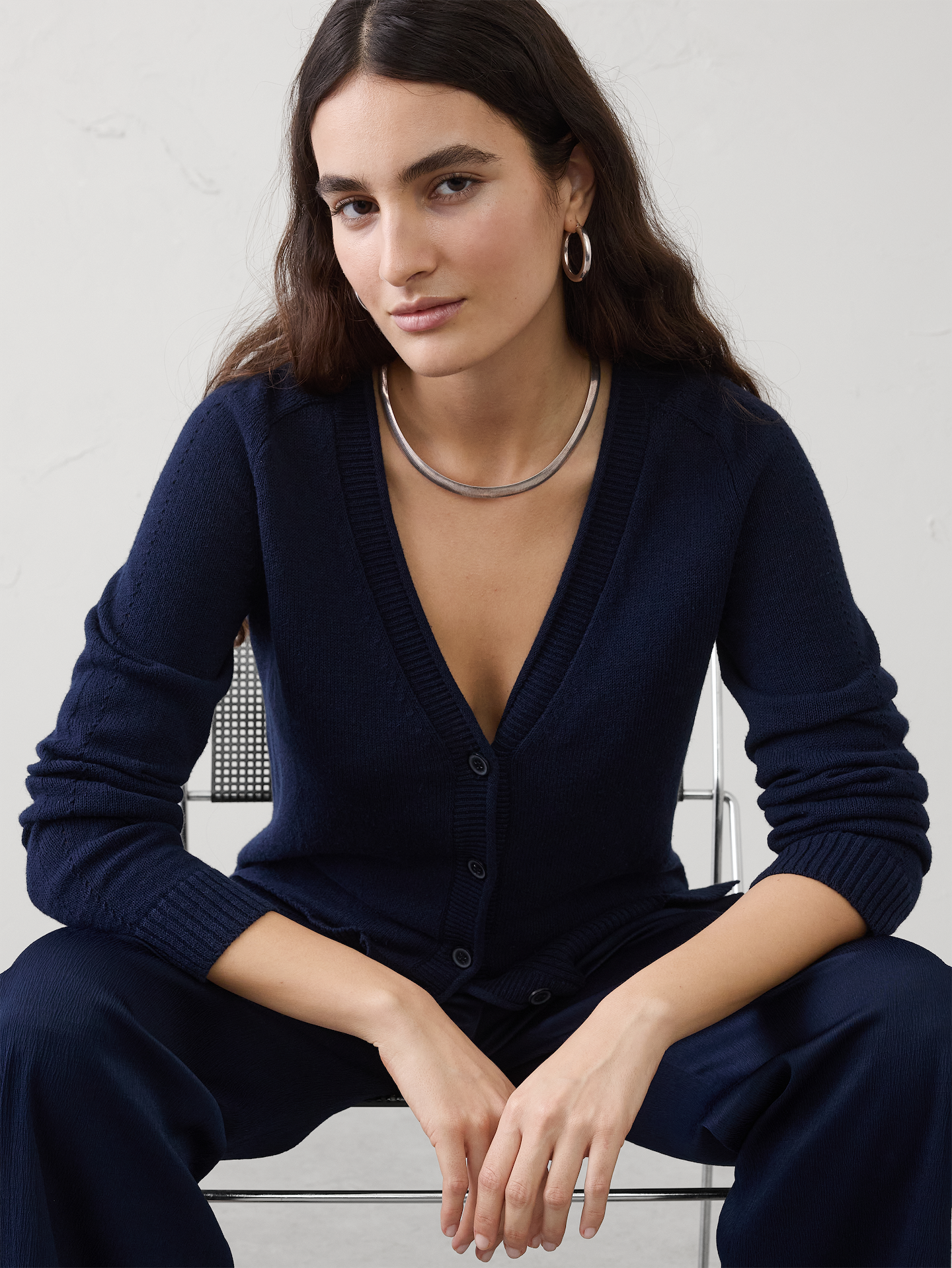 Image 1 of 4, Crafted from a beautifully breathable yarn, this cardigan feels soft and airy against the skin—light enough for warmer days yet still holding a softly tailored silhouette. Ramie’s natural texture lends a cool, lightweight hand feel with a subtly lustrous finish, giving the garment an effortless sense of ease and refined simplicity., Rolled vee neckline. Long sleeves., Ribbed neck, arm cuffs and hem., Features pointelle stitching on sides and sleeves., High-low hem with side slits., Made exclusively for Banana Republic Factory., Product #872806