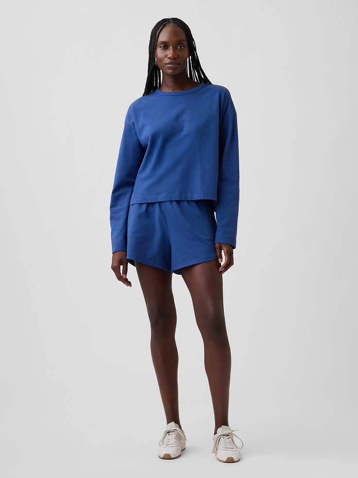 Image 1 of 6, Soft, heavyweight knit cotton dolphin shorts., Elasticized waist., Side on-seam pockets., Dolphin hem., This product was made in a factory that invests in gender equity and women’s empowerment through RISE. Learn more at gapinc.com/equity ., Product #896820