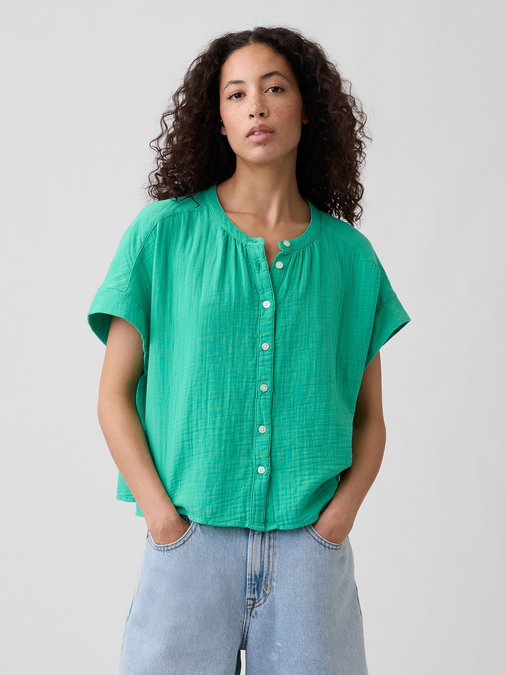Image 1 of 5, Gauze weave with crinkled texture., Short sleeves., Split neckline, button front., This product was made in a factory that invests in gender equity and women’s empowerment through RISE. Learn more at, Product #1174895