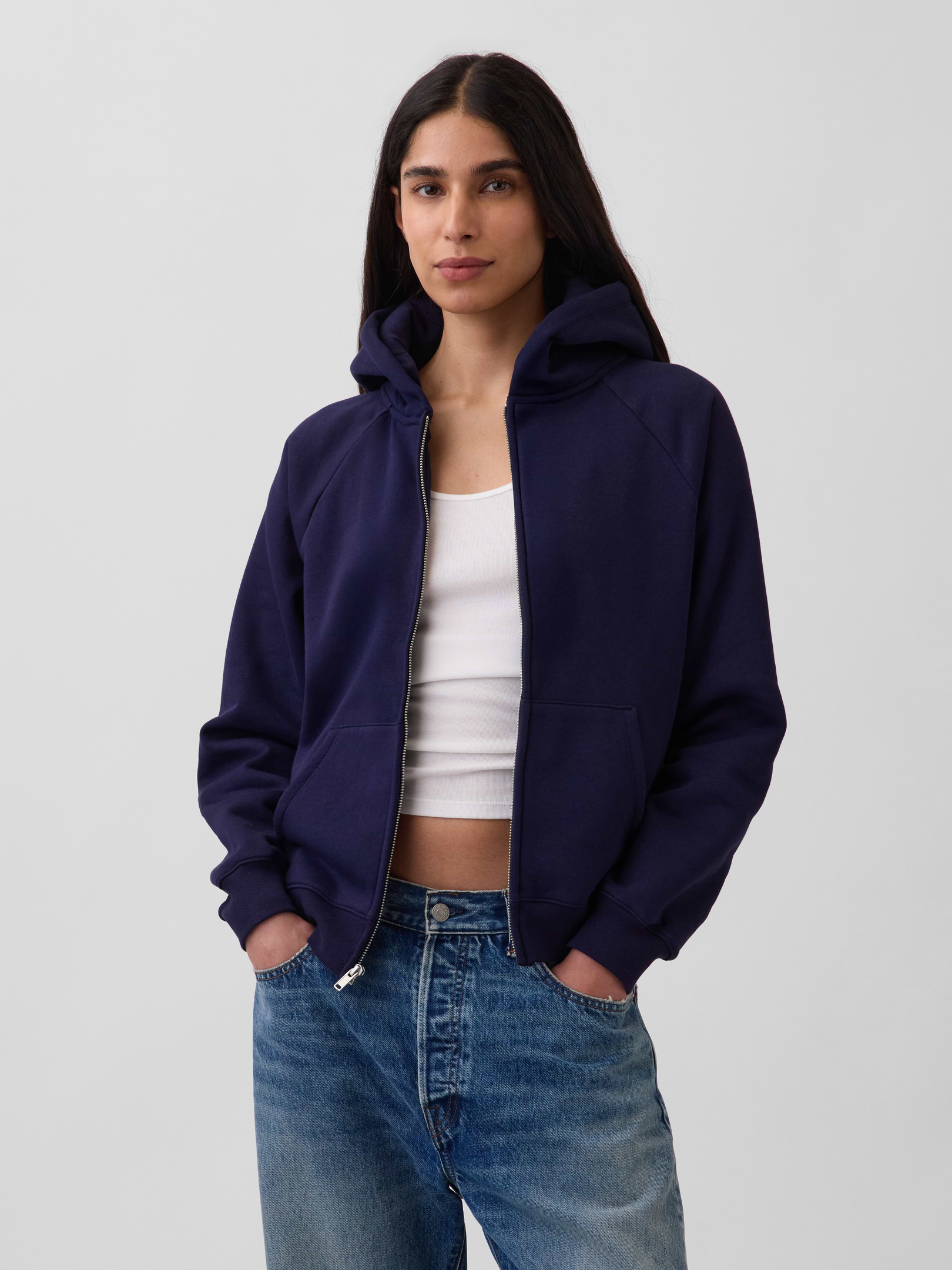 Image 1 of 6, Our softer than soft sweats. Brushed on the inside. Smooth on the outside. Made so that no two are alike., Soft cotton-blend fleece zip hoodie., Hooded neckline with drawcords., Long sleeves with banded cuffs., Zipper-front closure., Front kanga pockets., Banded hem., Explore our GapSweats Guide ., This product was made in a factory that invests in gender equity and women’s empowerment through RISE. Learn more at gapinc.com/equity ., Product #883546