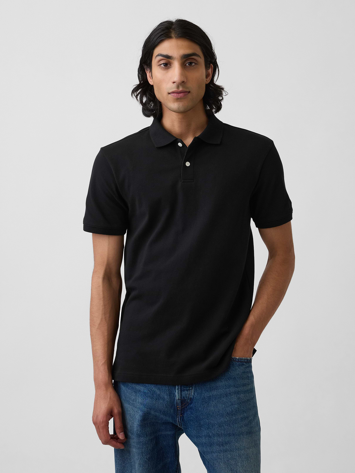 Image 1 of 4, Soft, stretch pique knit with moisture-wicking properties., Short sleeves with flat rib-knit cuffs., Flat rib-knit polo collar., Button placket., Side vents at hem., This product was made in a factory that invests in gender equity and women’s empowerment through RISE. Learn more at gapinc.com/equity ., Product #223627
