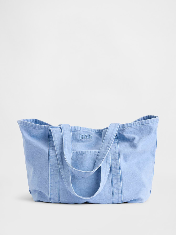 Image 1 of 5, Soft, overdyed cotton tote bag., Shoulder straps., Snap button closure., Outer and inner patch pocket., Embroidered mini Gap arch logo at front., Assorted colors & prints., Product #876406