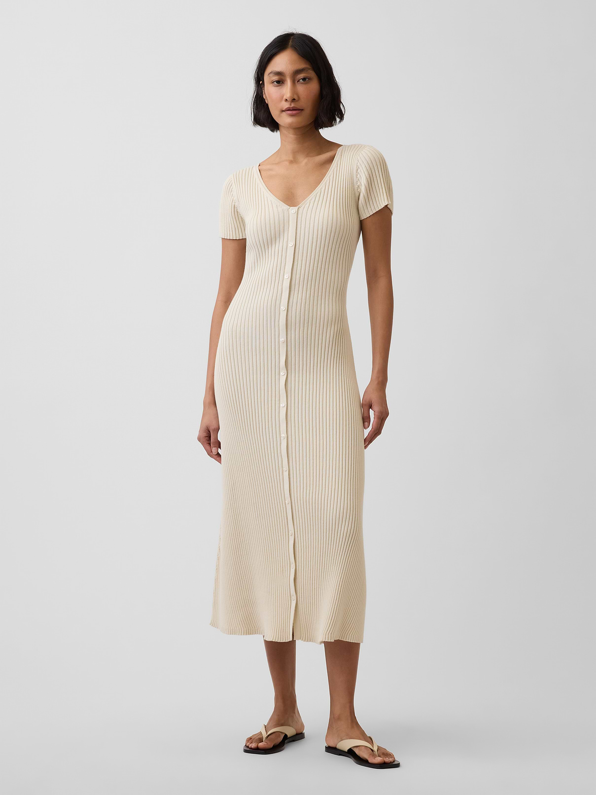 Image 1 of 6, Soft, ribbed cotton sweater knit maxi dress., V-neck at front and back., Short sleeves., Button front., This product was made in a factory that invests in gender equity and women’s empowerment through RISE. Learn more at gapinc.com/equity ., Product #898568