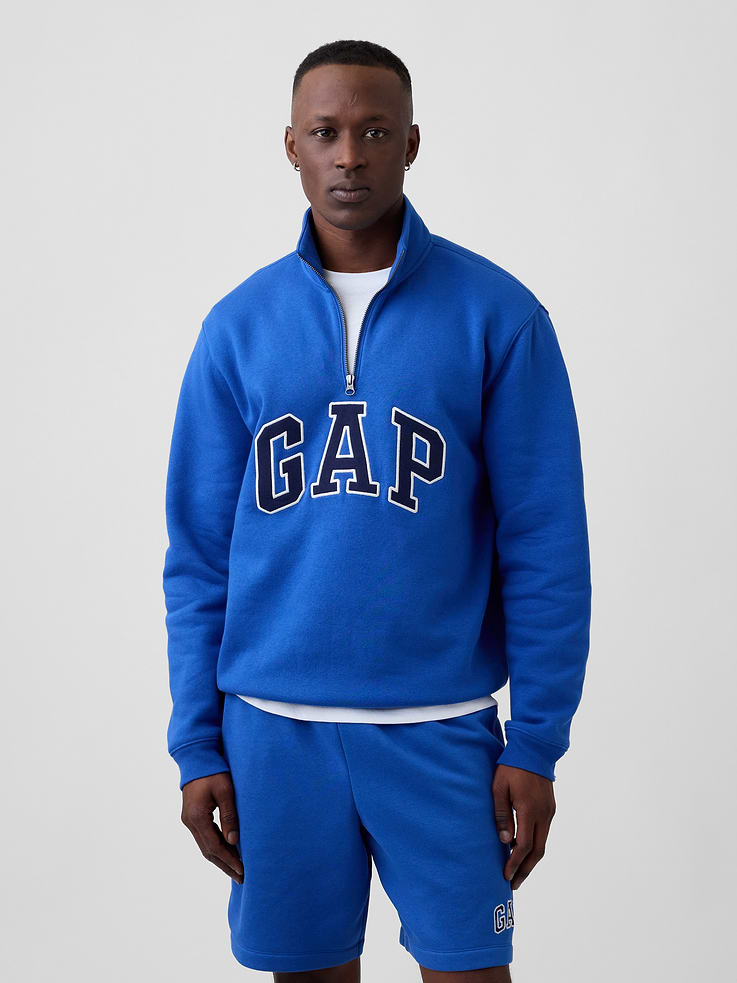Image 1 of 5, This product is made with/contains 23% recycled polyester. Compared to virgin materials, using recycled materials helps reduce resource use and waste., Soft, comfy fleece., Dropped shoulder, long sleeves with banded cuffs., Stand collar, quarter-zip front., Gap logo at front., Banded hem., Product #1187369