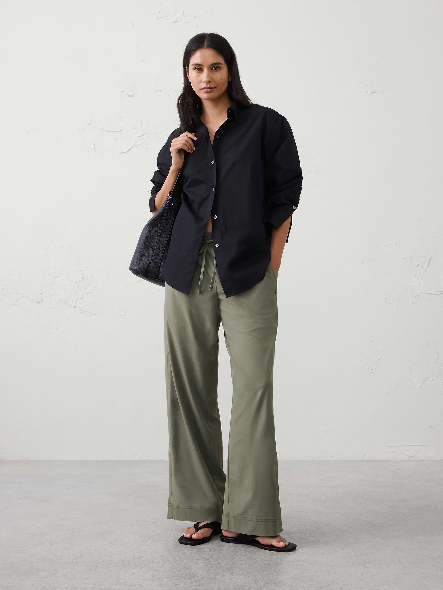 Image 1 of 5, A new silhouette in our signature on‑the‑go fabric, designed for ease and versatility. Lightweight and travel‑ready, it features a pull‑on waistband for all‑day comfort—perfect for everything from busy days to weekend getaways., Relaxed fit. Mid rise. Wide leg. Full length., Elasticized waistband with adjustable drawstring tie at center front., On-seam side pockets., Back welt pockets., Side-seam flap detailing on legs., Made exclusively for Banana Republic Factory., Product #1178124