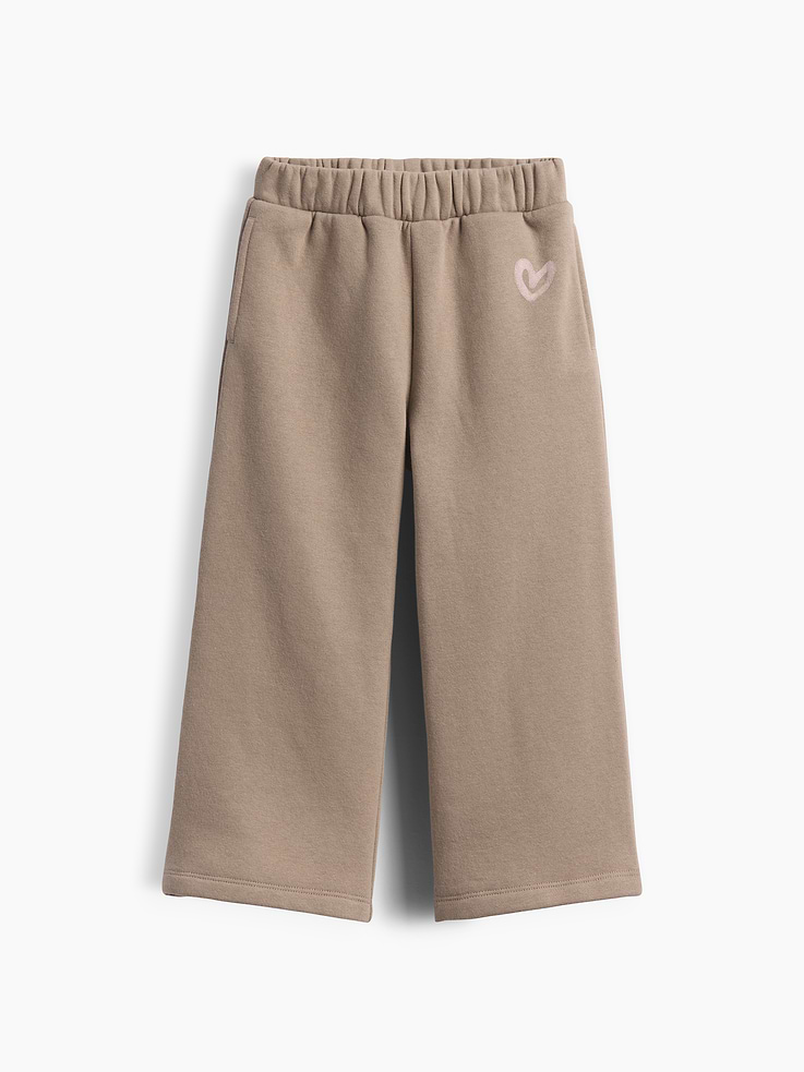 Image 1 of 2, Our softer than soft sweats. Brushed on the inside. Smooth on the outside. Made so that no two are alike., Soft cotton-blend fleece wide-leg sweatpants., Elasticized waist., Heart graphic at hip., Side on-seam pockets., Made with 52% Protocol cotton verified by the U.S. Cotton Trust Protocol, a program which works with farms committed to improving their environmental footprint by minimizing water usage and improving soil health (Claim No. 10127)., Made with 23% recycled polyester. Compared to virgin materials, using recycled materials helps reduce resource use and waste., Product #1183551