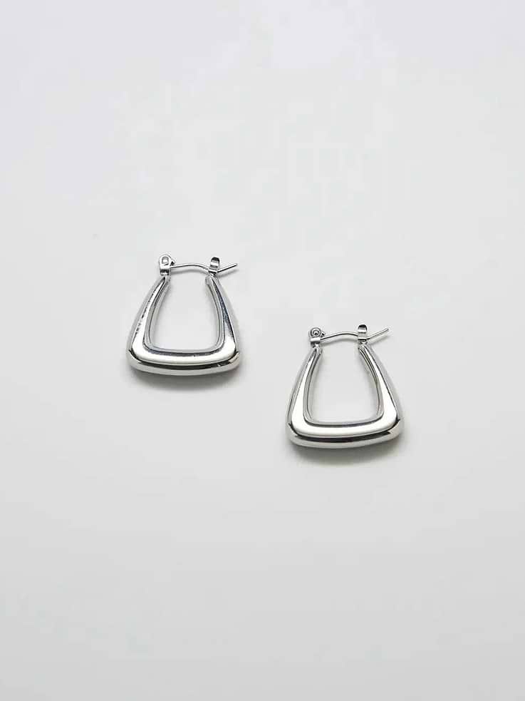 Image 1 of 1, Elevate your everyday look with these bold and beautiful Admiral Row Silver Triangle Hoop Earrings., These beautiful earrings are hollow for a lightweight but heavy-looking feel., They're perfect for an everyday look and can be stacked with our other tiny studs., Admiral Row takes pride in producing high-quality, handmade jewelry using only the best materials at affordable prices.