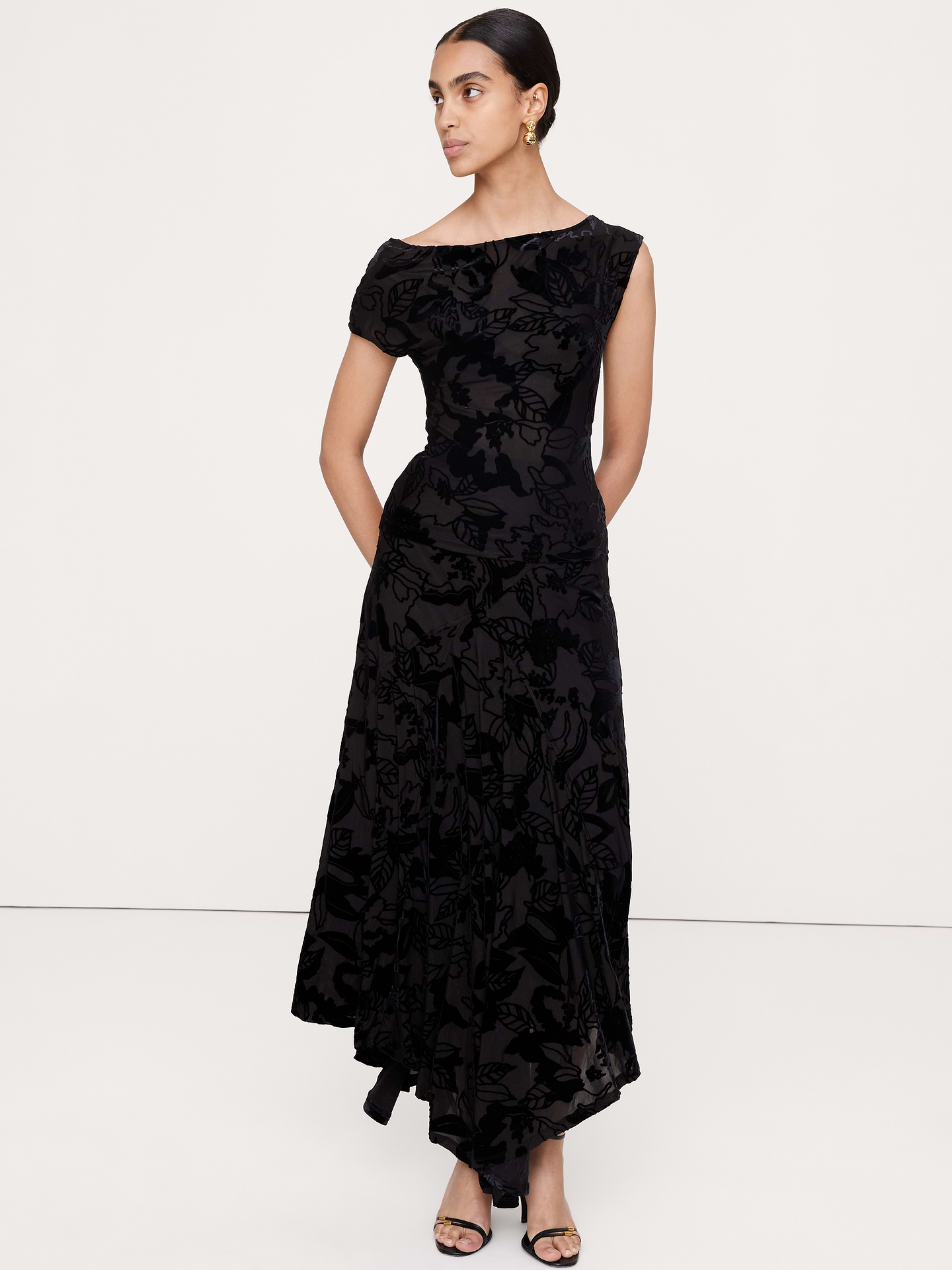 Image 1 of 5, Not your average maxi skirt, we cut this one from a festive burnout velvet that's so soft and stretchy. We used a wraparound construction with paneled inset to create an asymmetrical hemline that moves with every step., A-Line fit: High rise. Fitted waist with a flare silhouette., Elastic waistband (pull-on design)., Fully lined., Product #915540