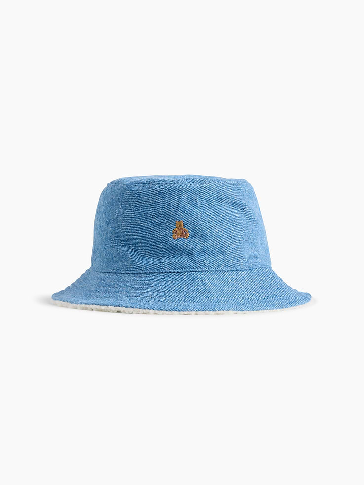 Image 1 of 2, Soft cotton denim bucket hat with a cozy sherpa lining., Stitching at wide brim., Embroidered Brannan Bear at front., Medium wash., Product #913053