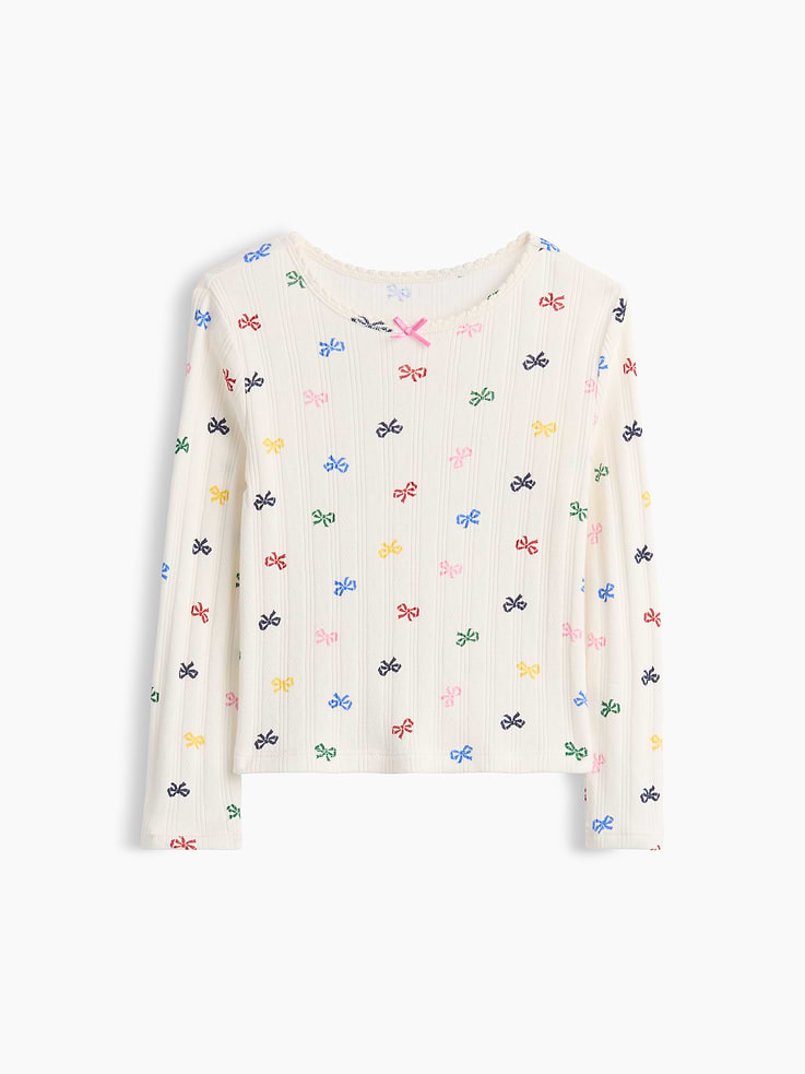 Image 1 of 2, Soft, ribbed pointelle-knit T-shirt., Round neckline with scalloped edge and tacked satin ribbon bow., Long sleeves., Product #1183552