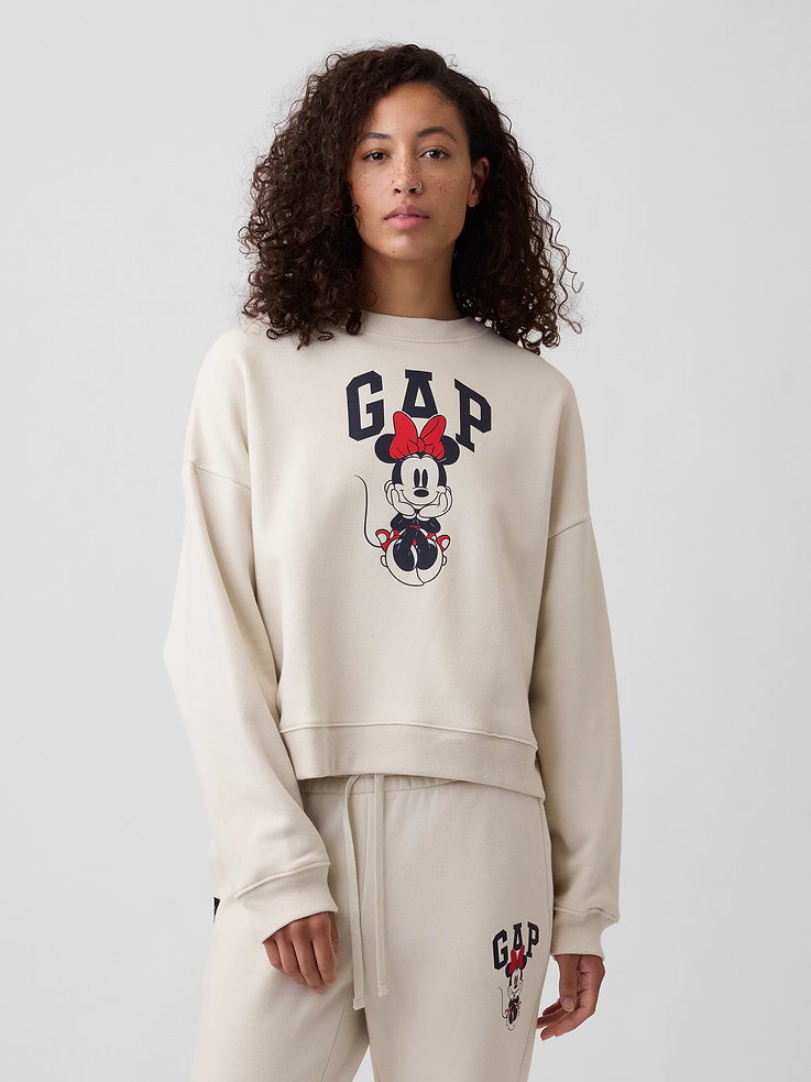 Image 1 of 5, This product is made with/contains 23% recycled polyester. Compared to virgin materials, using recycled materials helps reduce resource use and waste., Soft, comfy fleece., Dropped shoulder, long sleeves with banded cuffs., Crewneck., Gap logo with Minnie Mouse graphic at front., Banded wedge hem., Product #1178572