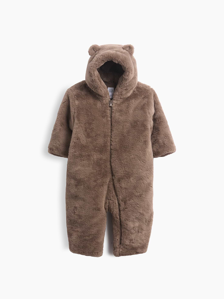 Image 1 of 2, Soft, cozy faux fur hooded baby one-piece., Hooded neckline with bear ear appliques at top., Long sleeves., Zipper front., Jersey-lined body., Explore our babyGap Guide ., This product was made in a factory that invests in gender equity and women’s empowerment through RISE. Learn more at gapinc.com/equity ., Product #1185660