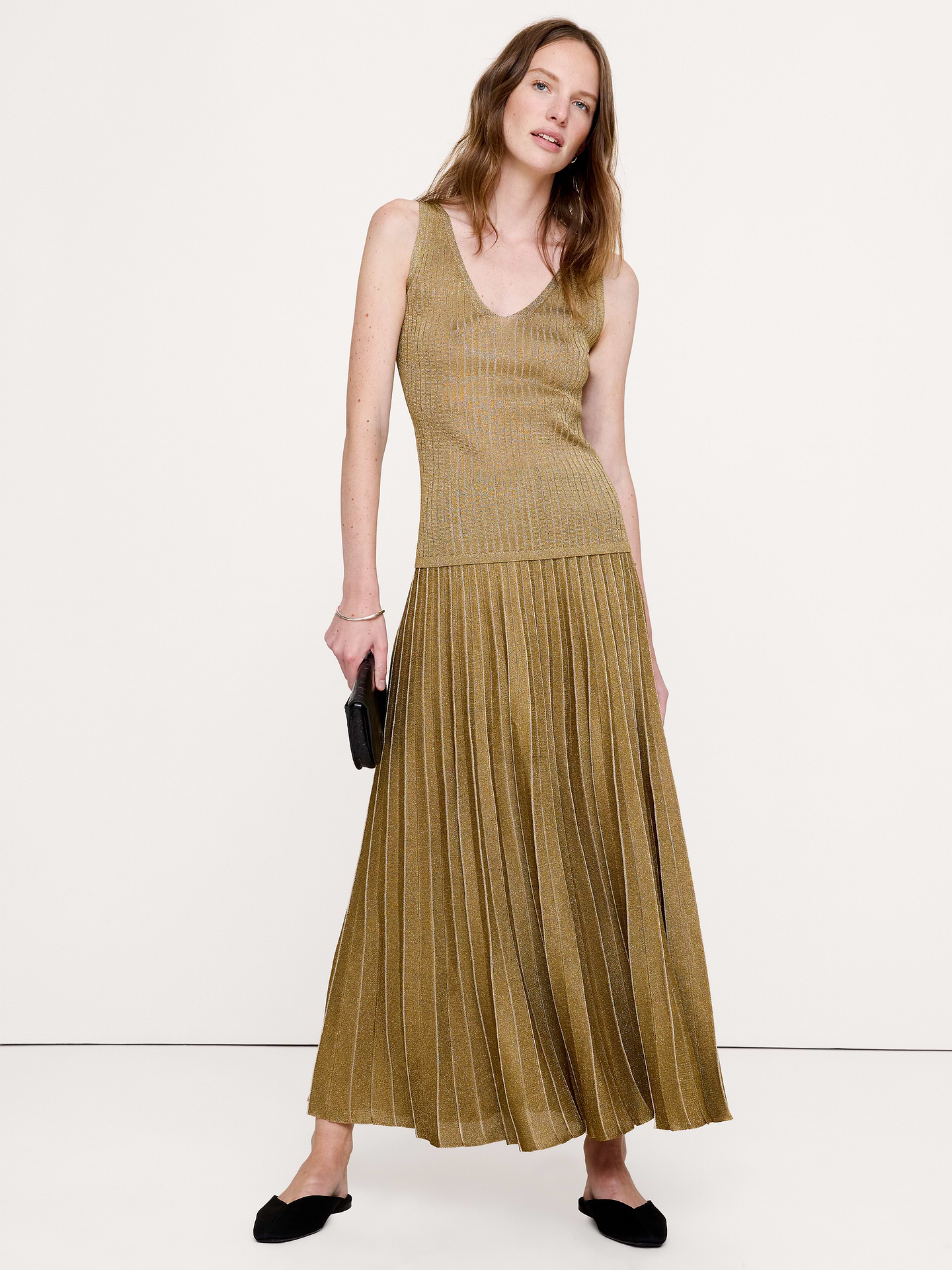Image 1 of 5, This sleek sweater tank is knitted using a subtly metallic yarn, enhanced by artfully arranged rib-knit stitches to enhance its figure-hugging silhouette., Fitted: Slim. Sits close to the body., Fabric from Italy's Lanificio dell'Olivo., V-neck., Straight hem., Product #1181559