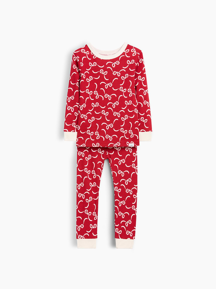 Image 1 of 2, Our comfiest PJs—now softer than ever. Cozy brushed cotton on the inside. All their favorite prints & colors on the outside., Soft organic cotton pajama top and pants PJ set with a cozy brushed interior., Crewneck., Long sleeves., Elasticized waist at PJ pant., Banded cuffs., Allover bow print., Made with 100% organically grown cotton which is grown without the use of synthetic pesticides and fertilizers., This product was made in a factory that invests in gender equity and women’s empowerment through RISE. Learn more at gapinc.com/equity ., Product #1186428