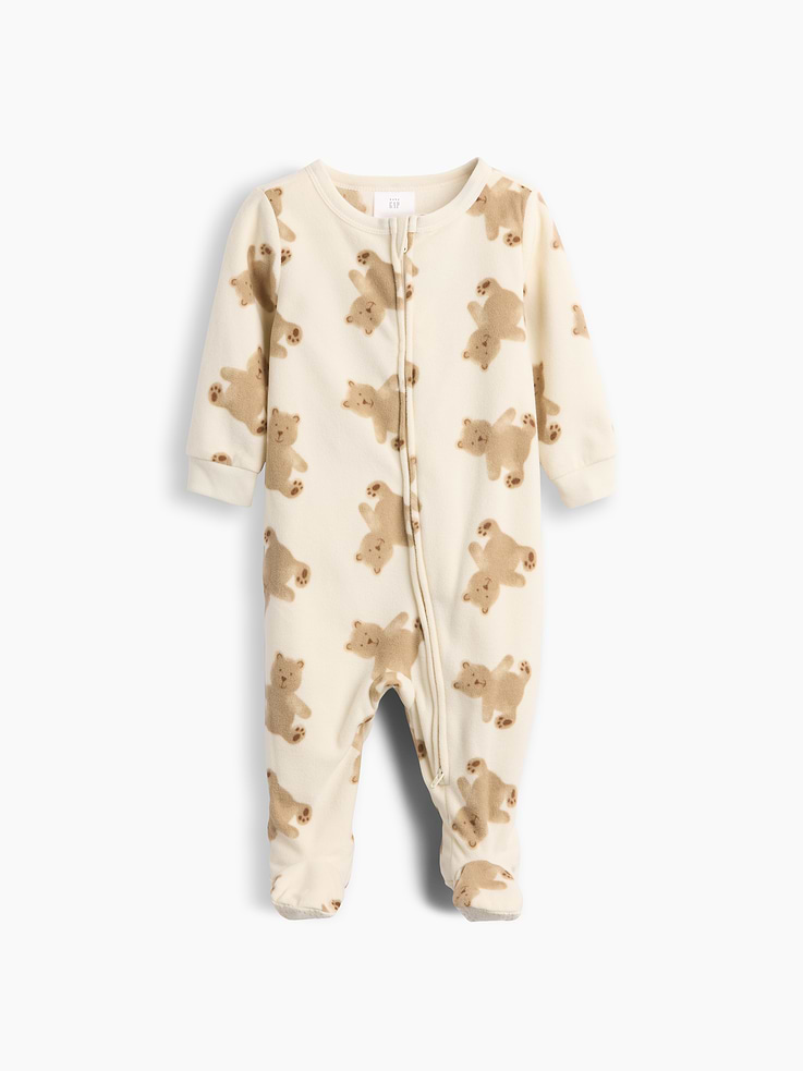 Image 1 of 3, Soft, cozy microfleece pajama footed one-piece., Crewneck with snap tab to protect little chins., Long sleeves with banded cuffs., Zipper front., Certain styles have an embroidered Brannan Bear at chest., Allover print., Made with 100% recycled polyester. Compared to virgin materials, using recycled materials helps reduce resource use and waste., This product was made in a factory that invests in gender equity and women’s empowerment through RISE. Learn more at gapinc.com/equity ., Product #915918