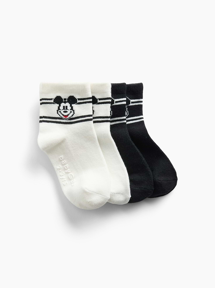 Image 1 of 1, Gap and Disney. Two timeless American brands. One collection that celebrates Mickey Mouse and Minnie Mouse., Soft stretch knit crew socks., Ribbed top., Reinforced toe and heel., Disney's Mickey Mouse graphic with striped detail., Made with 10% recycled polyester. Compared to virgin materials, using recycled materials helps reduce resource use and waste., Product #913667