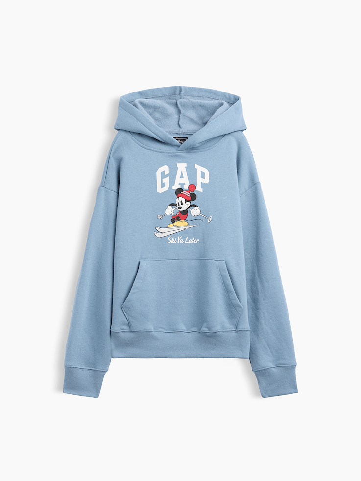 Image 1 of 3, A very special collaboration between Gap and Disney— two timeless, iconic American brands— led us to create a collection that celebrates Mickey Mouse and Minnie Mouse., This product is made with/contains at least 23% recycled polyester. Compared to virgin materials, using recycled materials helps reduce resource use and waste., Soft, comfy fleece., Dropped shoulder, long sleeves with banded cuffs., Hood., Gap logo with Mickey Mouse graphic at front., Kanga pocket., Banded hem., Product #1187817