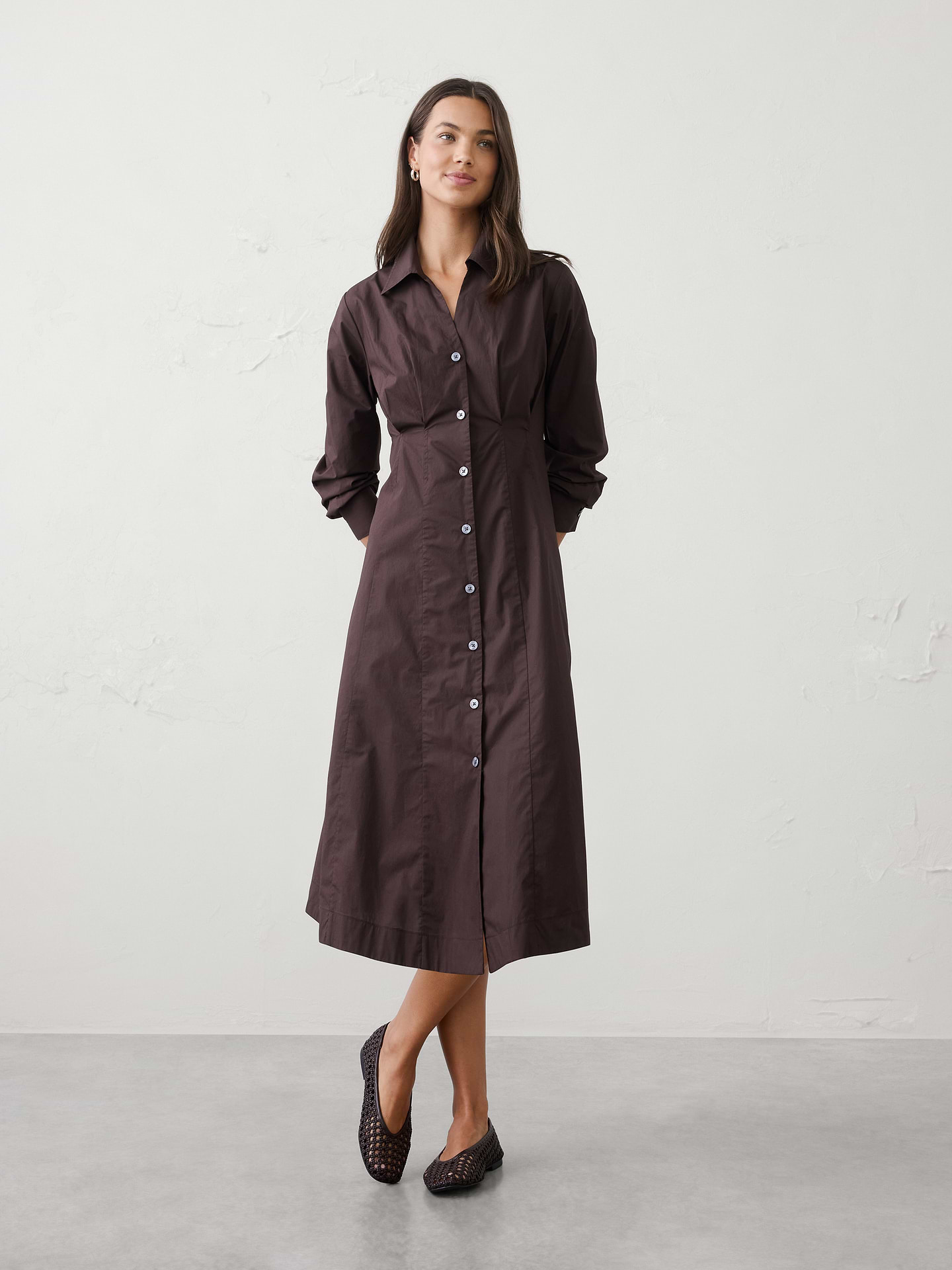 Image 1 of 4, Our Seamed-Waist Midi Shirtdress features tailored seaming that shapes the waist and creates a flattering, structured silhouette. Designed with a classic point collar and button‑front closure, it blends polished shirting details with soft, feminine volume through the skirt for an effortlessly refined look., Pointed collar with vee neckline. Long sleeves with button cuffs., Button front closure., Contoured princess seams run vertically through the bodice and the back., Skirt releases below the waist with soft flare., Flare hem., Made exclusively for Banana Republic Factory., Product #1180398