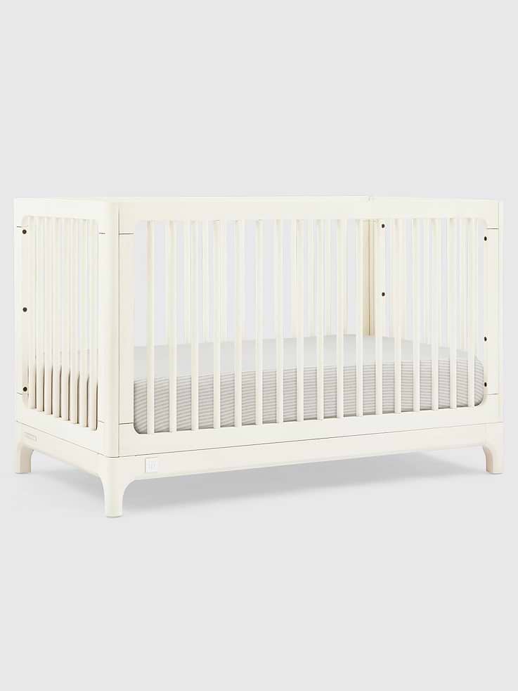Image 1 of 6, The babyGap Wren 4-in-1 Convertible Crib by Delta Children delivers style and comfort at each stage of your little one’s early years., This crib features a textured, glazed finish and wood working details at the base., A versatile piece of furniture that adjusts to your baby’s growth, this crib features three mattress heights, and transitions to a toddler bed, daybed and sofa when your child is ready (Daybed and Sofa Rail included; Toddler Guardrail sold separately)., This crib is Greenguard Gold certified to meet stringent chemical emissions standards., Safe for baby, this crib is JPMA certified to meet or exceed all safety standards set by the CPSC & ASTM., This crib uses a standard crib size mattress (sold separately).