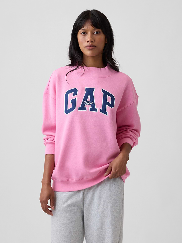 Image 1 of 5, This style is made with 23% recycled polyester. Compared to virgin materials, using recycled materials helps to reduce resource use and waste., Soft, comfy fleece., Dropped shoulder, long sleeves with banded cuffs., Mockneck., Gap logo at front., Banded hem., This product was made in a factory that invests in gender equity and women’s empowerment through RISE. Learn more at, Product #1174684