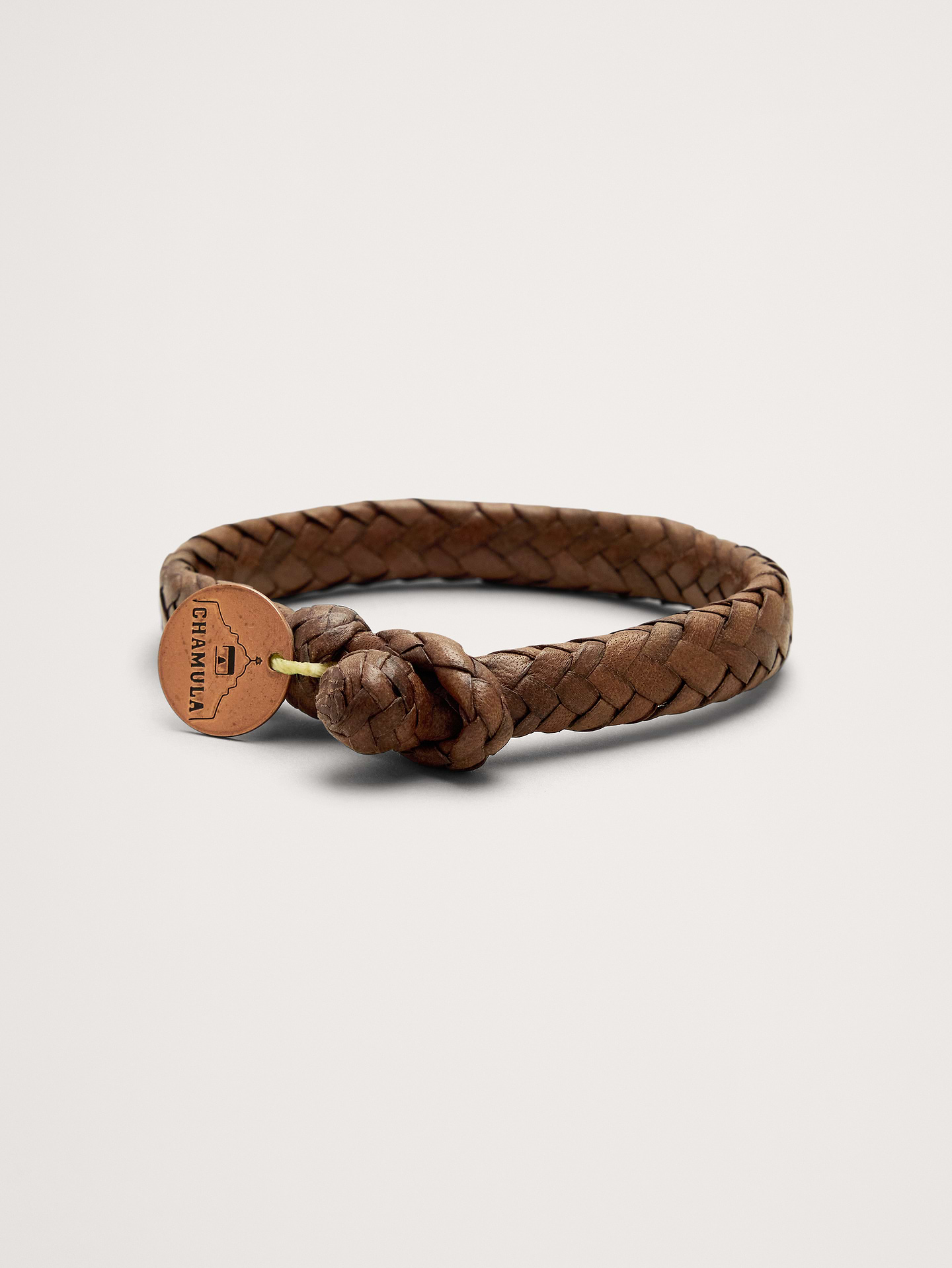 Image 1 of 5, This handwoven bracelet uses intricately braided flat leather strands and a branded coin to tell a considered story., Chamulas: Handcrafted goods by indigenous artisans in the Mexican highlands, rooted in traditional craft., Adjustable button closure., Product #899982