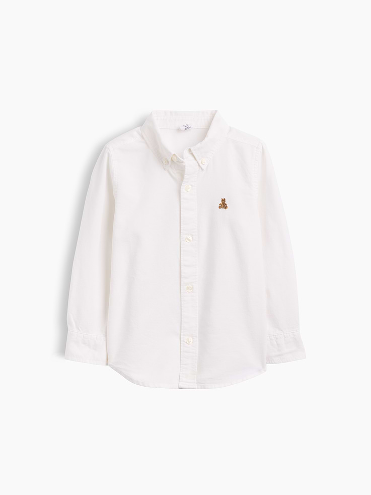 Image 1 of 1, Smooth oxford weave., Long sleeves with button cuffs, convertible button-tab closures., Button-down collar, button front., Curved shirttail hem., Due to inventory changes, only select styles have a patch pocket at chest, and pleat at back. You may receive a style without these details., This product was made in a factory that invests in gender equity and women’s empowerment through RISE. Learn more at, Product #437830