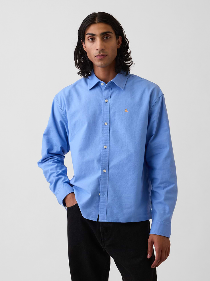 Image 1 of 5, Stretch organic cotton Oxford shirt. In a relaxed fit and cropped length., Spread collar., Long sleeves with button cuffs., Button front., Back yokes seam., Straight hem., Certain styles have an allover print., Certain styles have an embroidered Brannan Bear at chest., Made with 98% organically grown cotton which is grown without the use of synthetic pesticides and fertilizers., Product #909177