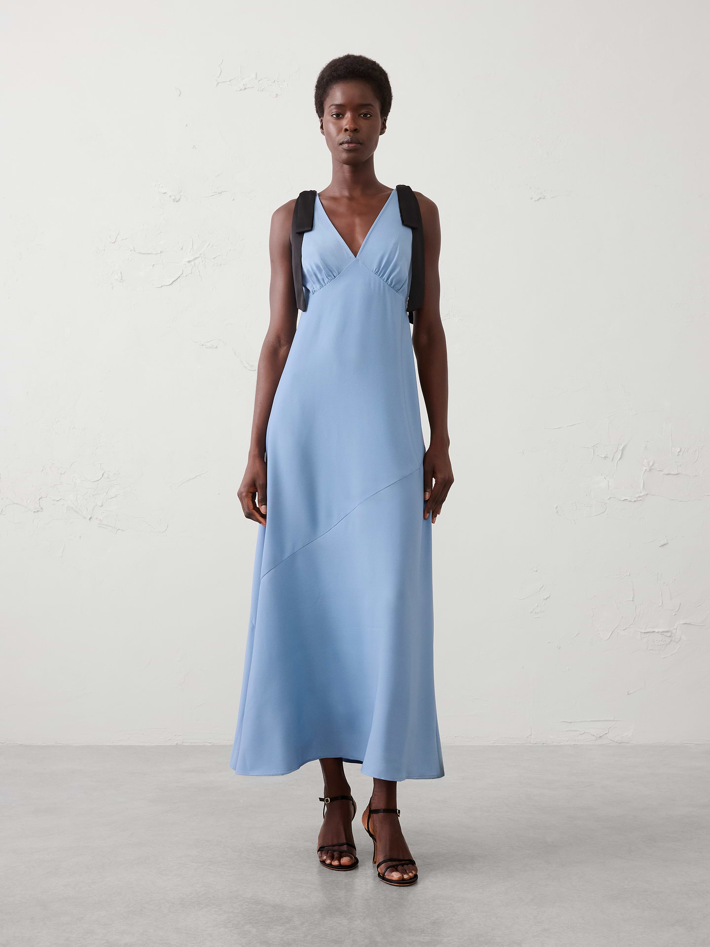 Image 1 of 3, V-neckline. Self‑tie shoulder straps., Empire waist seam., Bias‑cut skirt skims the body for a sleek, effortless fit., Flowing maxi‑length silhouette., Made exclusively for Banana Republic Factory., Product #1178216