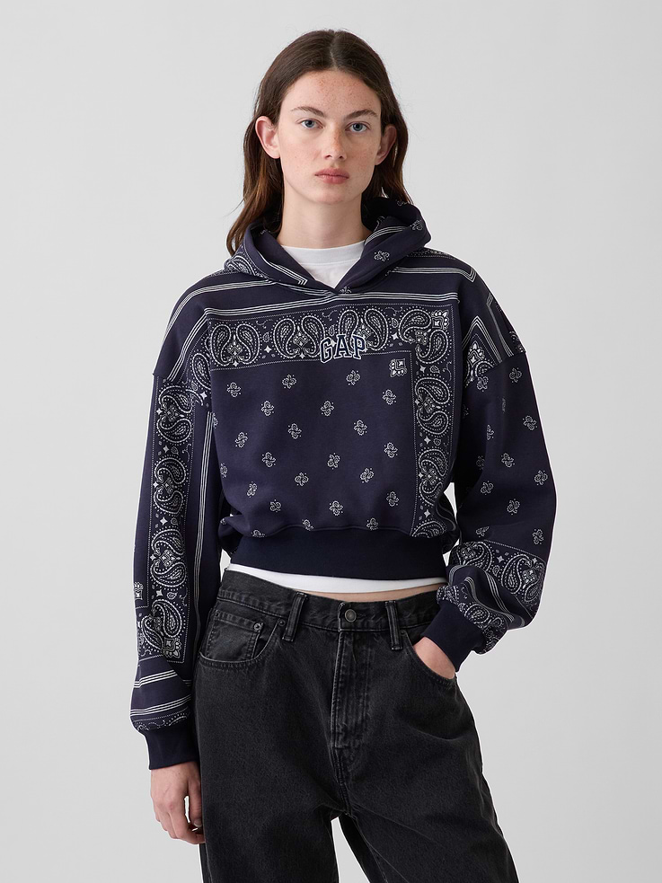 Image 1 of 7, Soft cotton-blend fleece hoodie. In an oversized fit and cropped length., Hooded neckline., Long sleeves with drop shoulders., Gap logo at front., Allover bandana print., Banded rib cuffs and hem., Made with 52% Protocol cotton verified by the U.S. Cotton Trust Protocol, a program which works with farms committed to improving their environmental footprint by minimizing water usage and improving soil health (Claim No. 10127)., Made with 23% recycled polyester. Compared to virgin materials, using recycled materials helps reduce resource use and waste., Product #1189403
