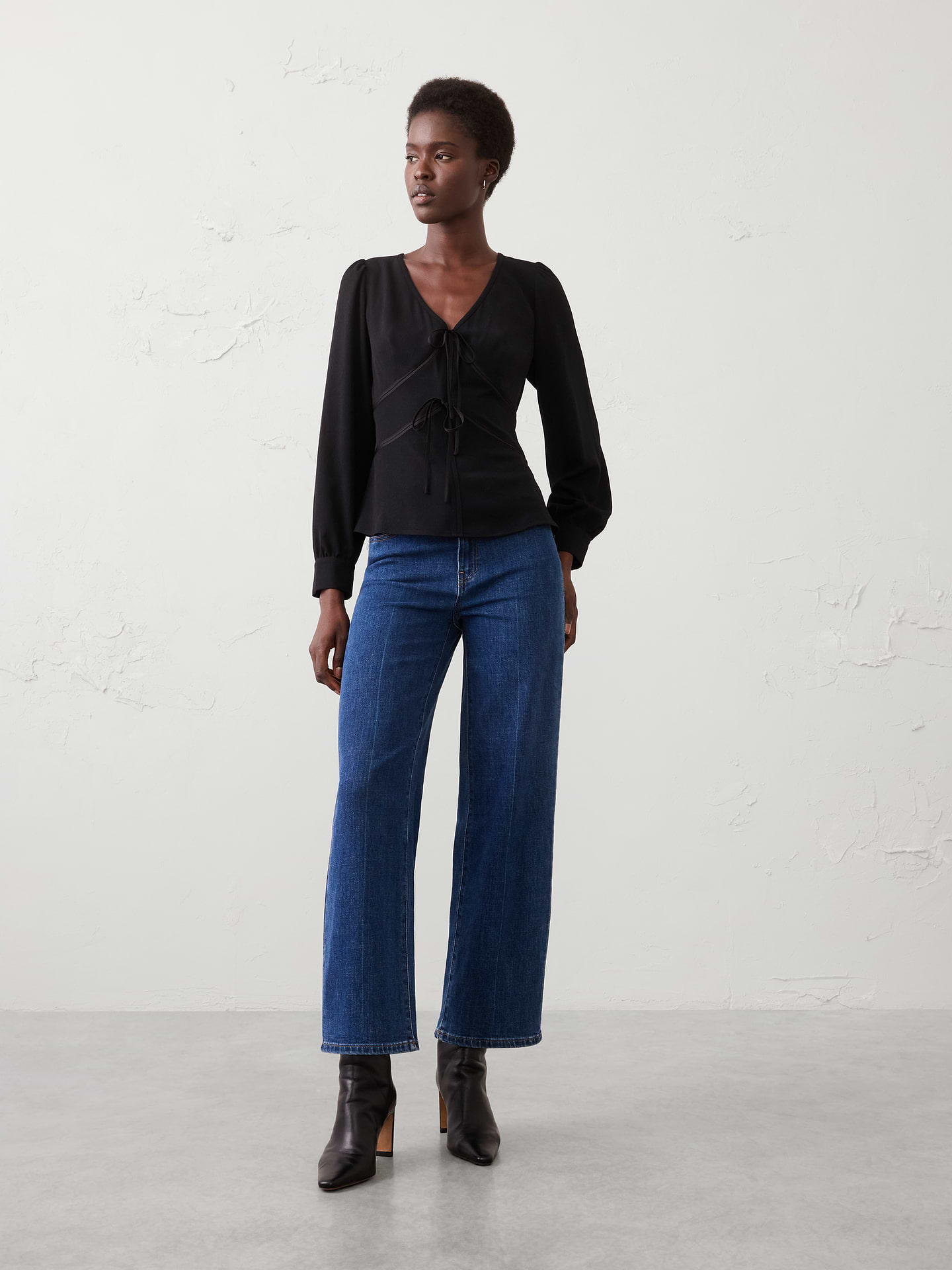 Image 1 of 3, Luxurious velvet trim elevates this flattering V‑neck silhouette with a touch of festive sophistication. Perfect for holiday occasions, it brings effortless elegance to everything from dinner parties to seasonal celebrations., V-neckline. Long blouson sleeves with buttoned cuffs., Contrast velvet trim outlines the front paneling., Tie‑front closure., Back shaping seams., Made exclusively for Banana Republic Factory., Product #1182785