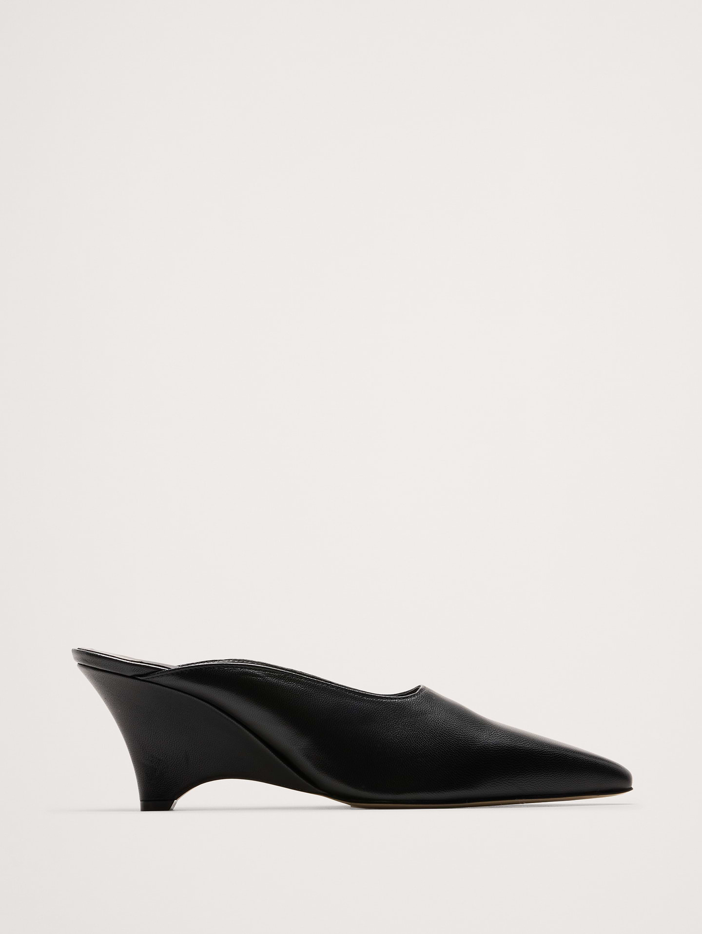 Image 1 of 5, This unique, architectural mid-heel wedge pump features a pointed toe, a minimal slip-on silhouette, and a low-cut vamp. Made from Italian leather., Freda Salvador: Woman-founded, artisan-made footwear blending bold design, comfort, and timeless craftsmanship., Leather uppers., Slip-on styling., Product #1190225