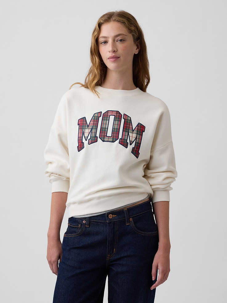 Image 1 of 5, This product is made with/contains 23% recycled polyester. Compared to virgin materials, using recycled materials helps reduce resource use and waste., Soft, comfy fleece., Dropped shoulder, long sleeves with banded cuffs., Crewneck., Mom graphic at front, Gap logo at sleeve., Banded wedge hem., This product was made in a factory that invests in gender equity and women’s empowerment through RISE. Learn more at gapinc.com/equity., Product #1173155