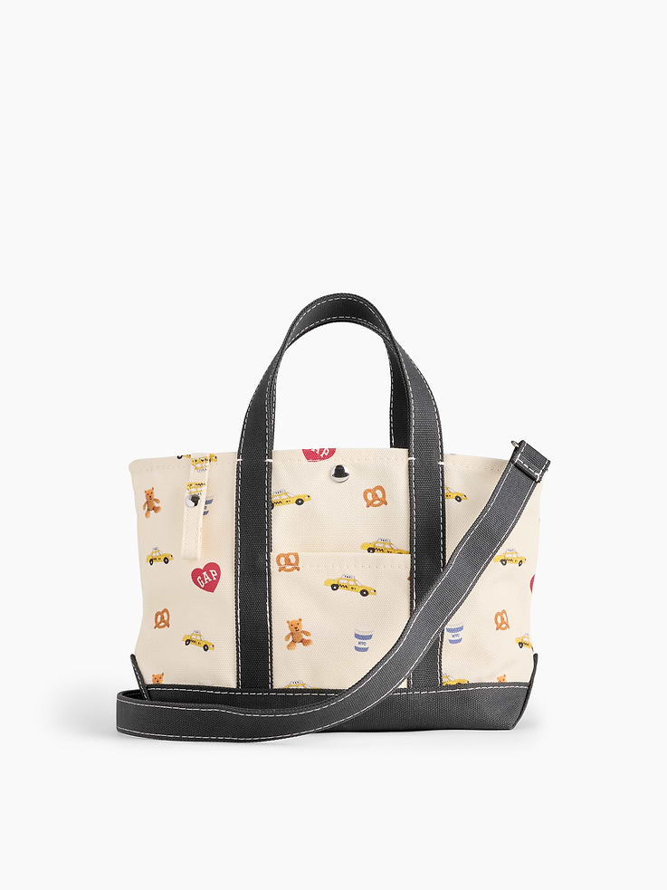 Image 1 of 3, Smooth cotton canvas mini tote bag., Snap button closure., Handles at top., Removable shoulder strap., Gap logo at front., Outer patch pocket., Certain styles have an allover print., Product #913013