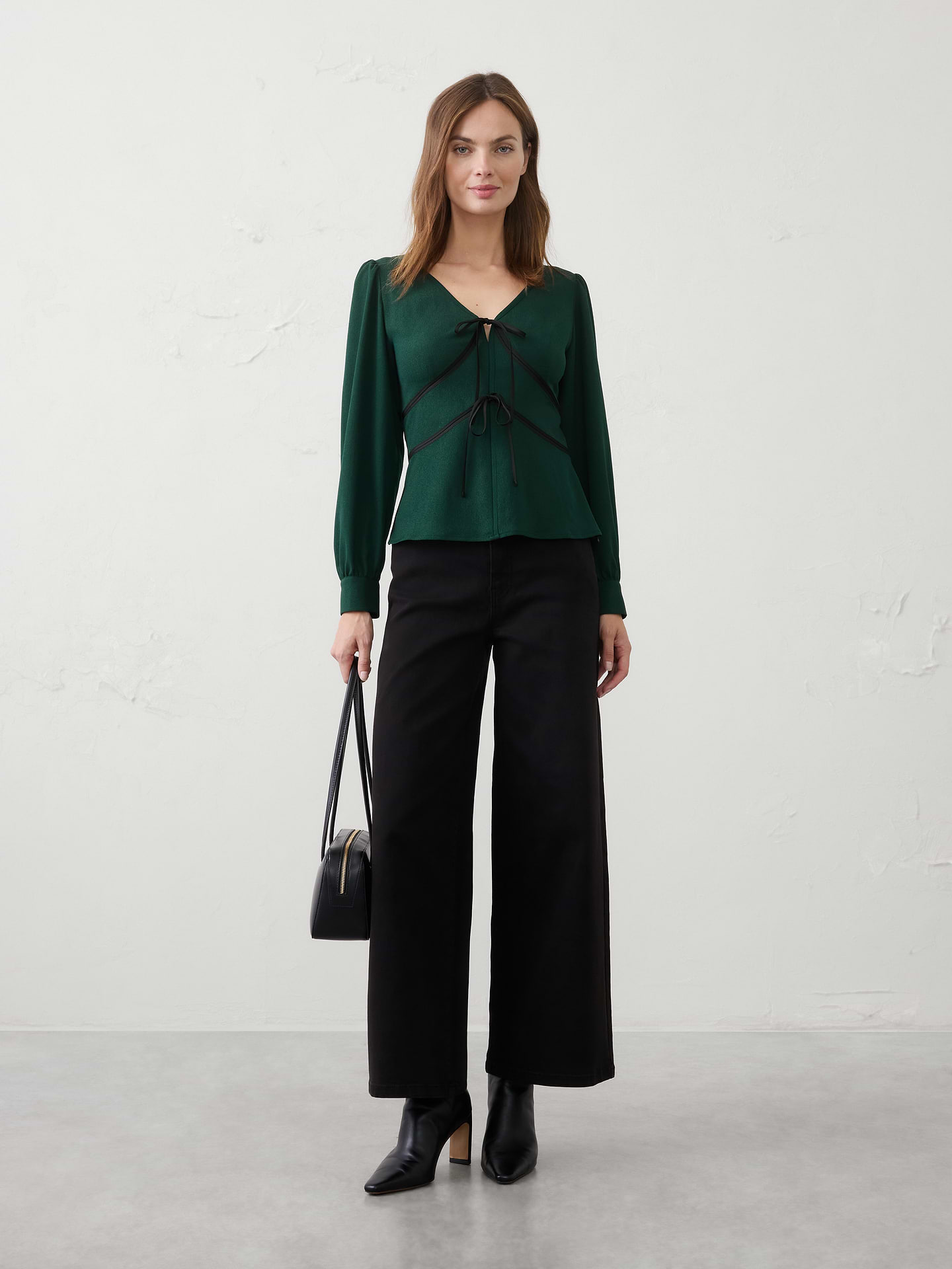 Image 1 of 3, Luxurious velvet trim elevates this flattering V‑neck silhouette with a touch of festive sophistication. Perfect for holiday occasions, it brings effortless elegance to everything from dinner parties to seasonal celebrations., V-neckline. Long blouson sleeves with buttoned cuffs., Contrast velvet trim outlines the front paneling., Tie‑front closure., Back shaping seams., Made exclusively for Banana Republic Factory., Product #1182785