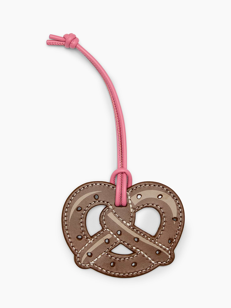Image 1 of 1, Smooth leather pretzel-shaped bag charm., Leather cord attached., Product #1192963