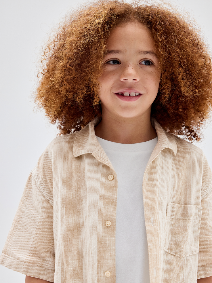 Image 1 of 4, Textured cotton knit., Short sleeves., Notch spread collar, button front., Patch pocket at chest., Select styles have allover print or stripes., This product was made in a factory that invests in gender equity and women’s empowerment through RISE. Learn more at, Product #1172809