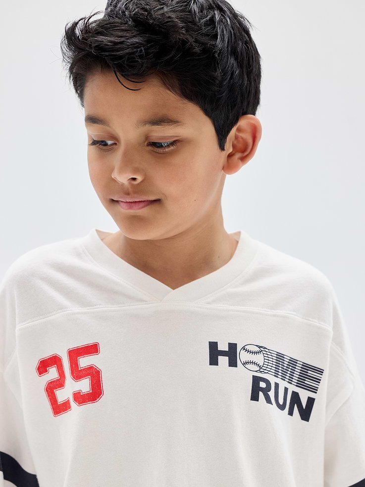 Image 1 of 4, Soft jersey knit., Dropped shoulder, stripes at elbow-length sleeves., V-neck., Graphics at front., This product was made in a factory that invests in gender equity and women’s empowerment through RISE. Learn more at, Product #1172494