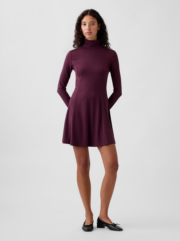 Image 1 of 5, Soft, stretch knit rayon mini dress., Mockneck., Long sleeves., Vertical seaming at front and back., This product was made in a factory that invests in gender equity and women’s empowerment through RISE. Learn more at gapinc.com/equity ., Product #1185327