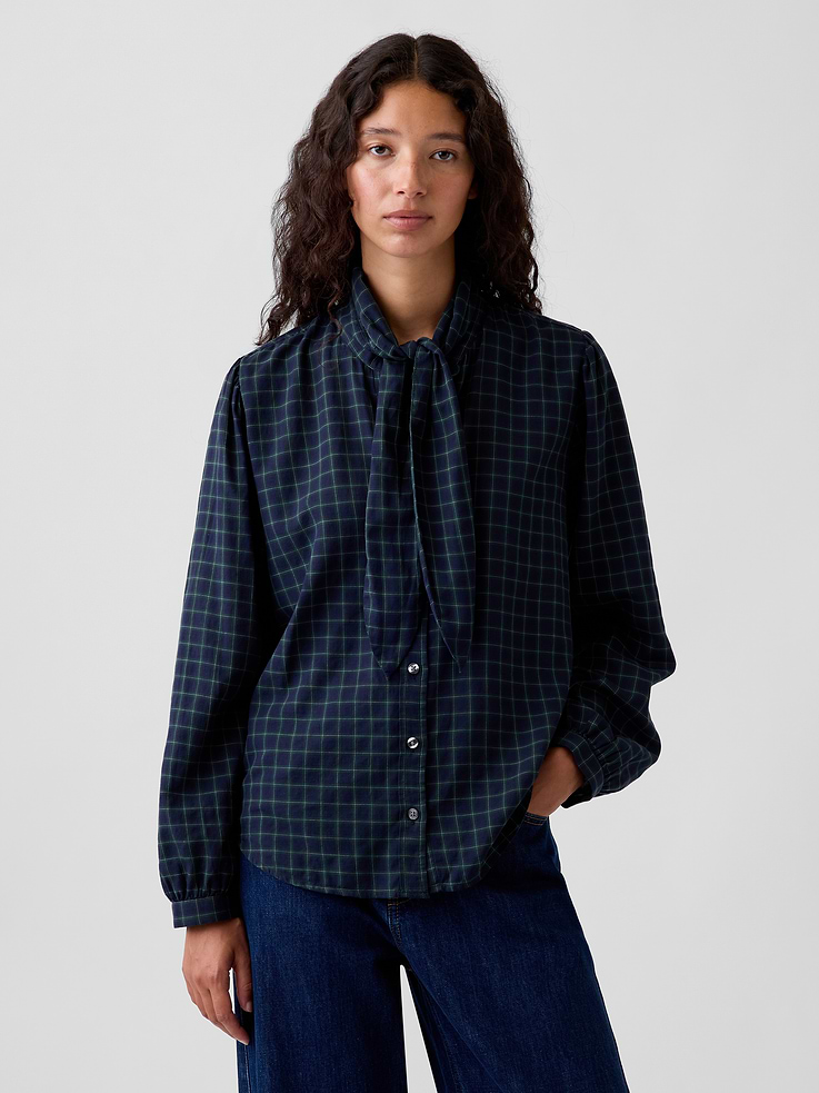 Image 1 of 5, Soft, lightweight stretch cotton twill button-up shirt., Tie neck with band collar., Long sleeves with button cuffs., Button front., Shirttail hem., Allover plaid., This product was made in a factory that invests in gender equity and women’s empowerment through RISE. Learn more at gapinc.com/equity ., Product #1184321